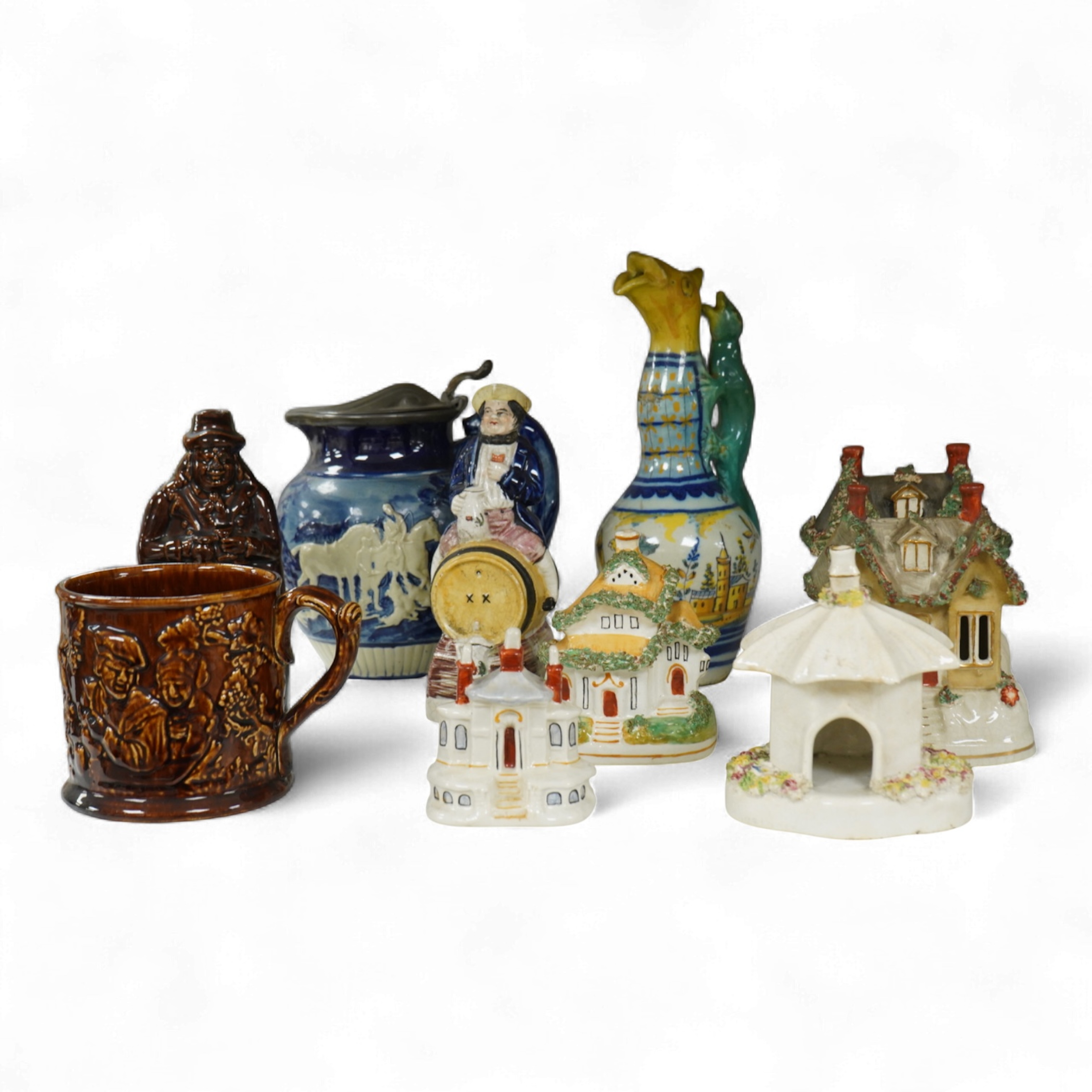 A group of various Victorian Staffordshire pottery models of cottages and various figure moulded vessels together with an Italian maiolica ewer, tallest 25cm